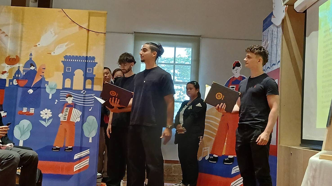 MCUT international students reciting the poem "Celle qui veille" (The One Who Watches) in French at the opening press conference.(Open new window/png file)Image